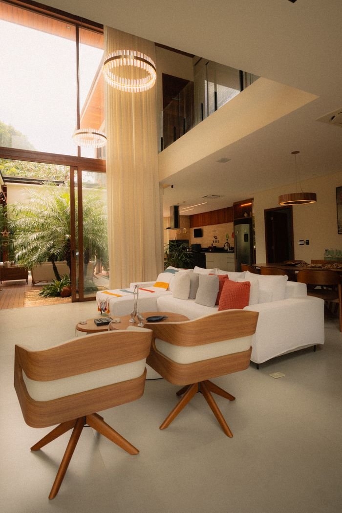 services-01 Spacious modern living room featuring luxurious furniture and abundant natural light through large windows.