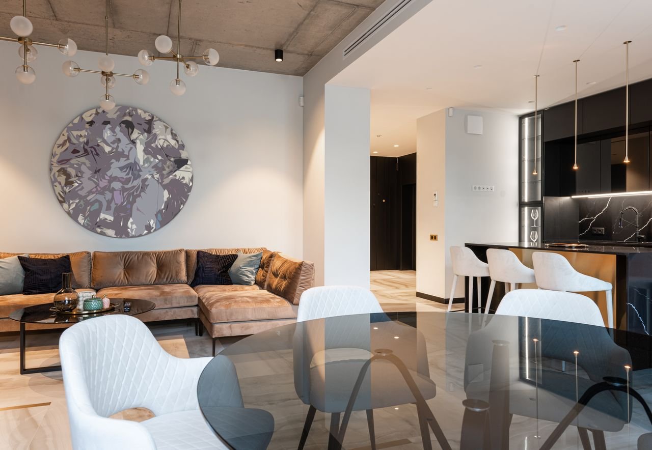 gallery-6 Spacious modern living room with chic decor and open kitchen setup. Perfect for interior design inspiration.